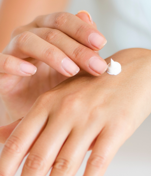 woman hands dollop of skincare cream