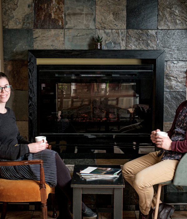 couple drinking coffee fireplace